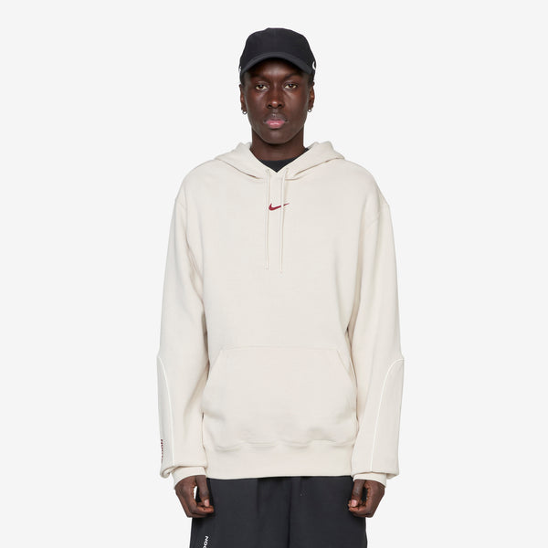 NOCTA Fleece Hoodie Light Orewood Brown | Team Red Jumpers